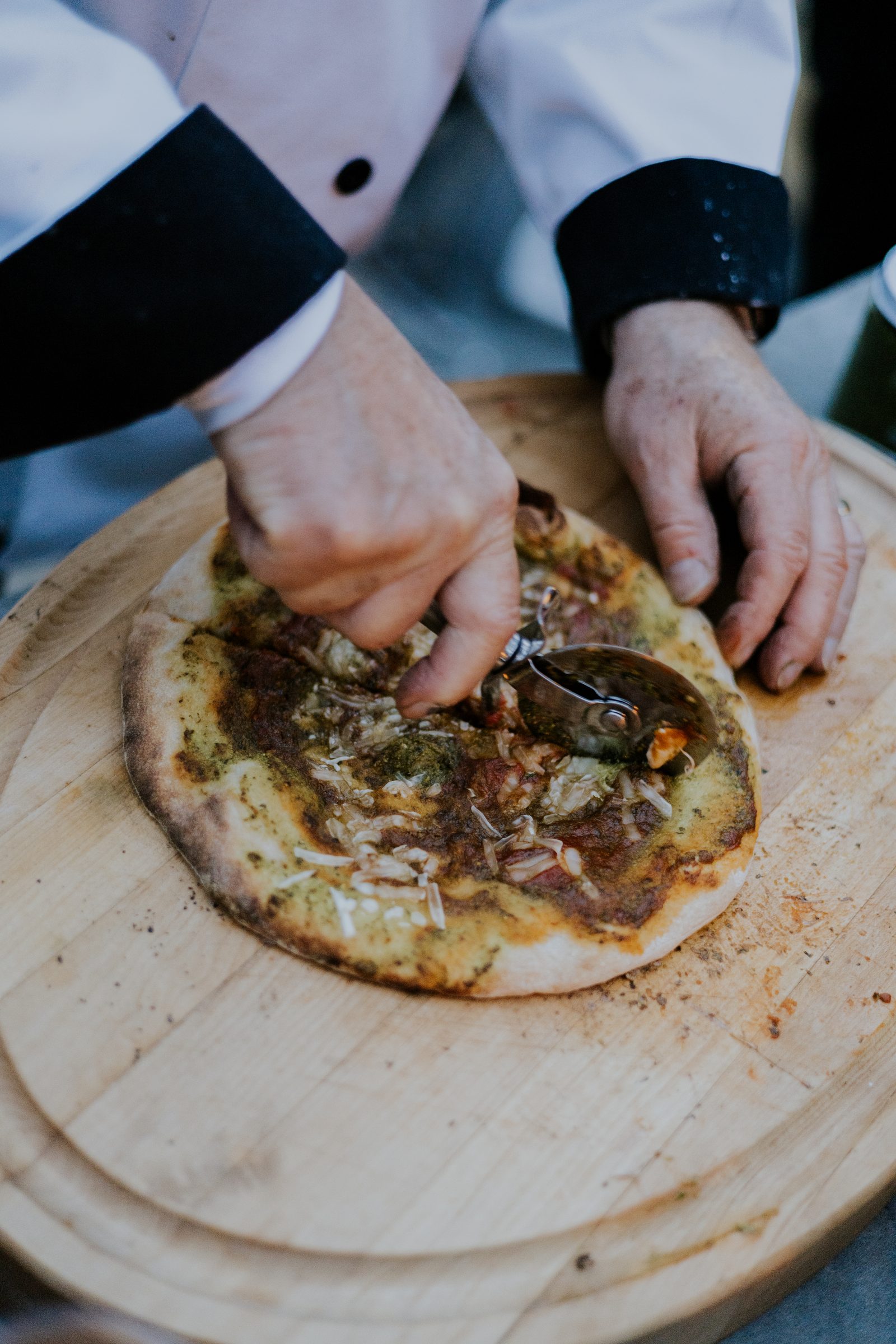 Finishing a pizza by hand